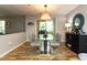 Dining room with glass-top table, contemporary chairs, and access to outdoor patio at 1911 Falls Landing Dr # 103, Raleigh, NC 27614