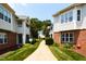 Exterior view of walkway between condo buildings with brick accents and meticulously maintained landscaping at 1911 Falls Landing Dr # 103, Raleigh, NC 27614