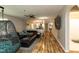 Stylish living room with dark leather sofa, ceiling fan and access to dining area at 1911 Falls Landing Dr # 103, Raleigh, NC 27614