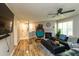Cozy living room with fireplace, hanging chair, and open layout to dining area at 1911 Falls Landing Dr # 103, Raleigh, NC 27614