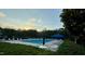 Community pool featuring lounge chairs, umbrella tables, and a relaxing atmosphere at 1911 Falls Landing Dr # 103, Raleigh, NC 27614