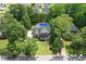 Aerial view of a home with mature trees and an inground pool at 2328 Forestbluff Dr, Fuquay Varina, NC 27526