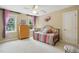 Comfortable bedroom with soft carpet, dresser, stylish bedframe, and natural light streaming through the windows at 2328 Forestbluff Dr, Fuquay Varina, NC 27526