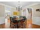 Dining room view, decorative molding, chandelier, and hardwood floors at 2328 Forestbluff Dr, Fuquay Varina, NC 27526