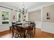 Cozy dining room with chandelier, decorative molding, and natural light at 2328 Forestbluff Dr, Fuquay Varina, NC 27526