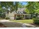 Lovely home featuring a spacious three-car garage, a covered front porch, manicured lawn, and beautiful landscaping at 2328 Forestbluff Dr, Fuquay Varina, NC 27526