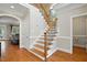 Elegant foyer with hardwood floors, staircase with iron balusters, and an open view into adjacent living spaces at 2328 Forestbluff Dr, Fuquay Varina, NC 27526