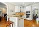 Well-lit kitchen with stainless steel appliances, granite countertops, and hardwood floors at 2328 Forestbluff Dr, Fuquay Varina, NC 27526