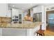 Bright kitchen featuring stainless steel appliances, granite countertops, and hardwood floors at 2328 Forestbluff Dr, Fuquay Varina, NC 27526