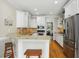 Well-lit kitchen with stainless steel appliances, granite countertops, and hardwood floors at 2328 Forestbluff Dr, Fuquay Varina, NC 27526
