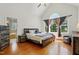 Bedroom with hardwood floors, ceiling fan, and a large window at 2328 Forestbluff Dr, Fuquay Varina, NC 27526