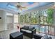 A screened porch has a ceiling fan, tile floor, and overlooks the pool and back yard at 2328 Forestbluff Dr, Fuquay Varina, NC 27526