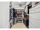 Spacious walk-in closet featuring custom shelving, shoe racks, and ample hanging space for clothes and accessories at 2328 Forestbluff Dr, Fuquay Varina, NC 27526