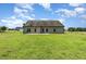Lush backyard featuring a grassy lawn, partial fencing and a concrete patio, ideal for entertaining at 235 Camden Place St, Princeton, NC 27569