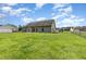 Spacious backyard with well-maintained lawn, fencing, and a cozy patio area, perfect for outdoor living at 235 Camden Place St, Princeton, NC 27569