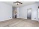 Spacious bedroom with carpet, a view of the bathroom and an organized walk-in closet at 235 Camden Place St, Princeton, NC 27569