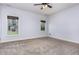 Bright bedroom features neutral carpet and two windows offering ample natural light at 235 Camden Place St, Princeton, NC 27569