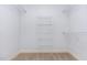 Walk-in closet includes installed shelving for organized storage at 235 Camden Place St, Princeton, NC 27569
