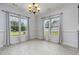 Bright dining area with tiled floors, windows, and modern lighting at 235 Camden Place St, Princeton, NC 27569