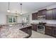 Well-lit kitchen boasts stainless steel appliances, dark cabinets, and granite countertops at 235 Camden Place St, Princeton, NC 27569