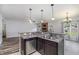 Open kitchen with granite countertops and stainless steel dishwasher overlooks the living room at 235 Camden Place St, Princeton, NC 27569