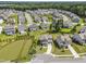 Aerial view of neighborhood featuring homes surrounding a pond at 2527 Sidewinder Ct, Apex, NC 27523