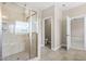 Elegant bathroom featuring a glass enclosed shower with seating and neutral tone tile work at 2527 Sidewinder Ct, Apex, NC 27523
