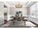 Elegant dining room with modern lighting, stylish furniture, and refined wall decor at 2527 Sidewinder Ct, Apex, NC 27523