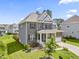 Beautiful two-story home with manicured lawn and attached garage with brick and siding accents at 2527 Sidewinder Ct, Apex, NC 27523