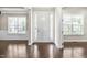 Bright foyer with polished hardwood floors, a white front door, and ample natural light at 2527 Sidewinder Ct, Apex, NC 27523