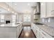 Bright kitchen featuring granite counters, stainless appliances, and center island with pendant lighting at 2527 Sidewinder Ct, Apex, NC 27523