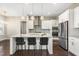 Modern kitchen featuring white cabinetry, stainless steel appliances, and a granite-topped island with seating at 2527 Sidewinder Ct, Apex, NC 27523