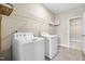 Functional laundry room with a modern washer, dryer, and wire rack shelves at 2527 Sidewinder Ct, Apex, NC 27523