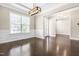 Inviting living room featuring dark hardwood floors, crown molding, and a large window at 2527 Sidewinder Ct, Apex, NC 27523