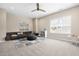 Well-lit living room with a comfy gray sofa, colorful accents, and a view to the outdoors at 2527 Sidewinder Ct, Apex, NC 27523