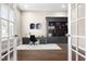 Well-appointed office with a built-in bookshelf, a desk, and French doors for privacy at 2527 Sidewinder Ct, Apex, NC 27523