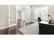 Stylish office space with French doors, a comfortable chair, and natural light from a window at 2527 Sidewinder Ct, Apex, NC 27523