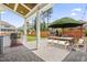 Outdoor patio features a built-in grill, an outdoor dining area, and a stone fireplace for outdoor entertainment at 2527 Sidewinder Ct, Apex, NC 27523