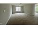 Spacious bedroom with carpet, natural light, and a view of the surrounding neighborhood at 2852 Orchard Trace Way, Raleigh, NC 27610