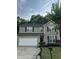 Charming two-story home with neutral siding, black shutters, a well-manicured lawn, and a two car garage at 2852 Orchard Trace Way, Raleigh, NC 27610