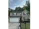 Charming two-story home with neutral siding, black shutters, a well-manicured lawn, and a two car garage at 2852 Orchard Trace Way, Raleigh, NC 27610