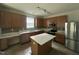 Modern kitchen featuring stainless steel appliances, island with quartz countertops, and tile backsplash at 2852 Orchard Trace Way, Raleigh, NC 27610