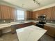 Modern kitchen featuring stainless steel appliances, island with quartz countertops, and tile backsplash at 2852 Orchard Trace Way, Raleigh, NC 27610