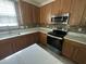 Modern kitchen featuring stainless steel appliances, quartz countertops, and new backsplash at 2852 Orchard Trace Way, Raleigh, NC 27610