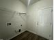 Practical laundry room featuring wood flooring and door to the exterior at 2852 Orchard Trace Way, Raleigh, NC 27610