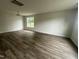 Bright living room features new hardwood floors, modern lighting, and a large window at 2852 Orchard Trace Way, Raleigh, NC 27610