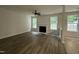 Inviting living area with a fireplace, new hardwood floors, natural light, and a ceiling fan at 2852 Orchard Trace Way, Raleigh, NC 27610