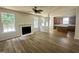 Open-concept floor plan with a living room featuring a fireplace that connects to the modern kitchen at 2852 Orchard Trace Way, Raleigh, NC 27610