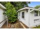 View of a light colored back exterior of the house with an unkept yard at 303 N Watauga Ave, Dunn, NC 28334