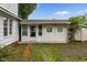 Backyard view of home, fence, and outbuilding with a well-lit exterior at 303 N Watauga Ave, Dunn, NC 28334